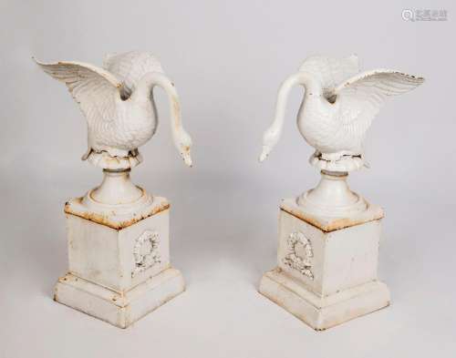 A pair of painted cast iron swan garden ornaments on stands,...