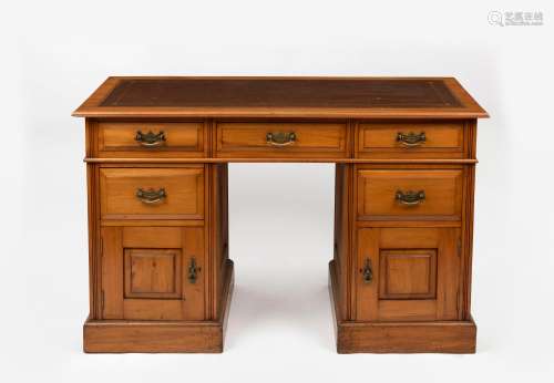 An antique Australian twin pedestal desk, kauri pine with em...