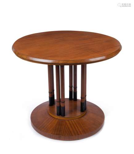 An Austrian circular occasional table, ribbon veneer mahogan...