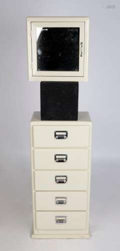 A vintage medical wall cabinet and chest of drawers with cre...