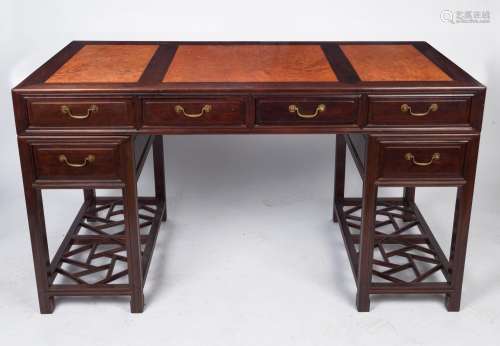 A Chinese rosewood twin pedestal desk with inlaid amboyna pa...