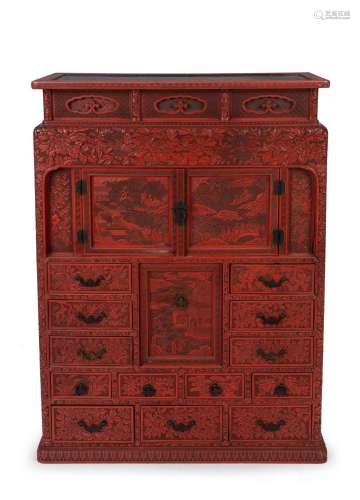 An antique Japanese red lacquered cabinet, profusely decorat...