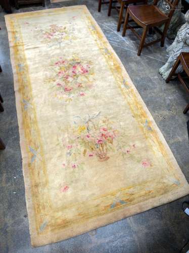 An Aubusson style wool rug with floral motif, 20th century, ...