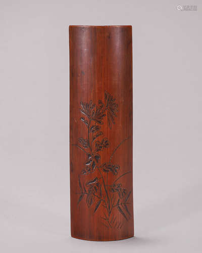 A flower carved bamboo arm rest