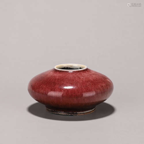 A red glazed porcelain water pot