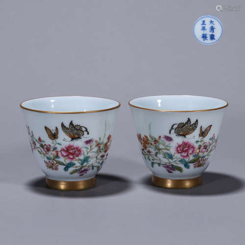 A pair of famille rose flower and butterfly porcelain cups