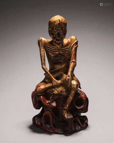 A gilt wood monk statuette