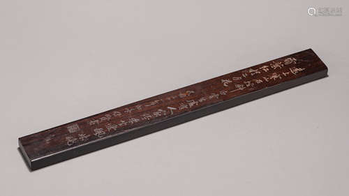 An inscribed red sandalwood paperweight