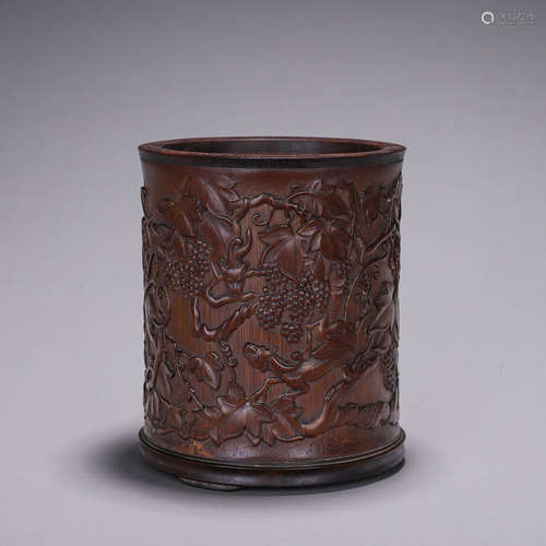 A beast and grape carved bamboo brush pot