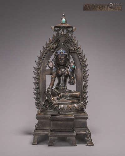 A silver-inlaid copper green tara statue