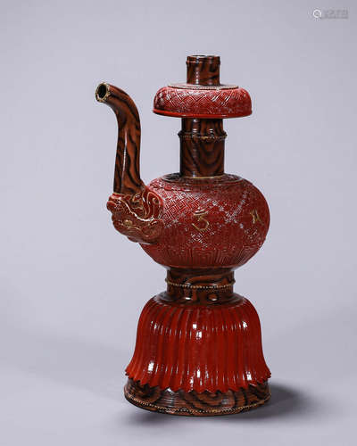 An inscribed red glazed porcelain ewer