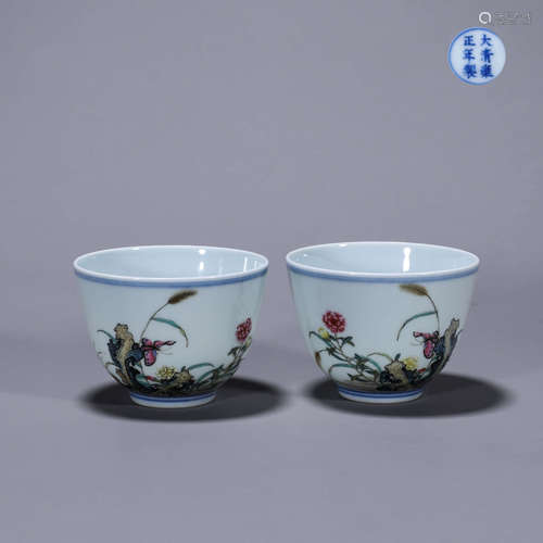 A pair of famille rose flower and butterfly porcelain cups