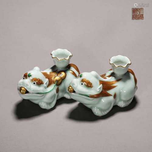 A pair of celadon glazed porcelain beast flower holders