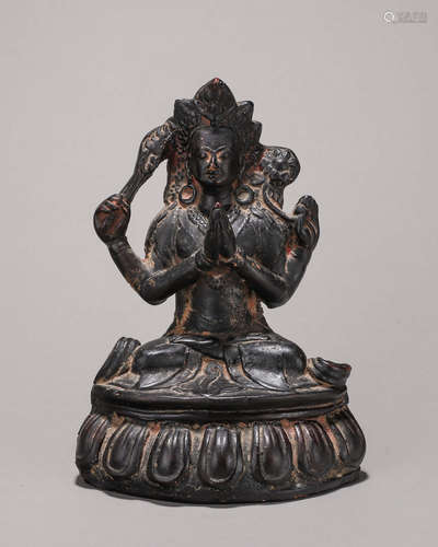 A copper four-armed Manjusri statue