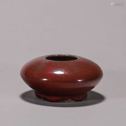 A red glazed porcelain water pot