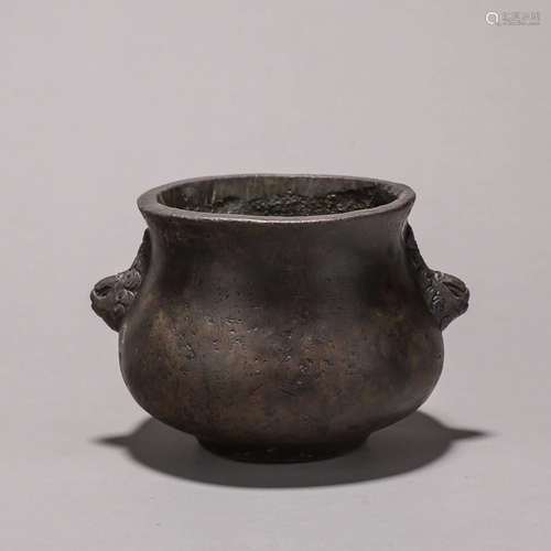 A copper censer with lion head shaped ears