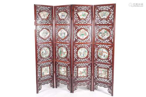 A Chinese folding room divider with famille verte panels