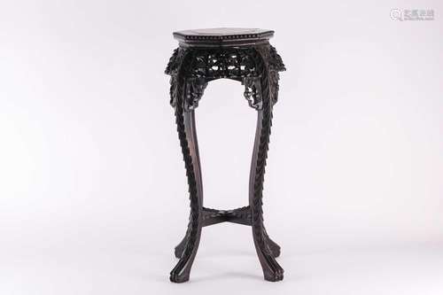 A Chinese carved hardwood vase stand