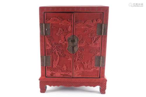 A Chinese cinnabar lacquer table cabinet