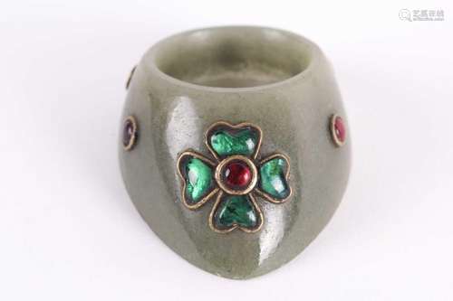 An Indian moss green jade archer's ring yellow metal set wit...