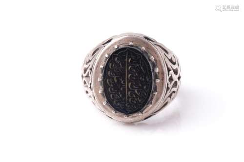 An Eastern white metal and black onyx signet ring with pierc...