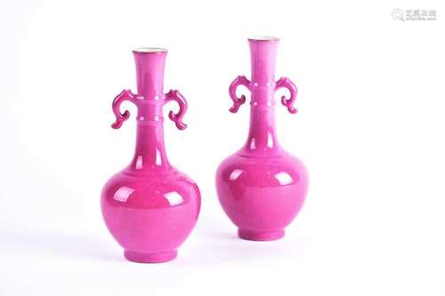 A pair of Chinese rose pink glazed twin handled vases