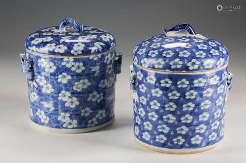 A near pair of Chinese blue & white containers and covers