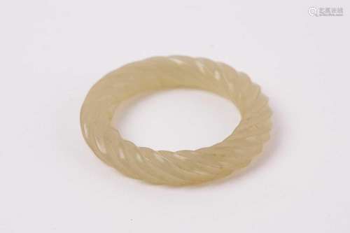 A Chinese green jade rope twist ring