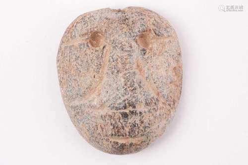 A Chinese Hongshan style carved stone face mask pendant