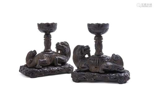 An unusual pair of Chinese zitan wood candle holders