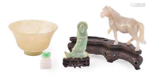 A Jadeite carving of a figure standing on a fish