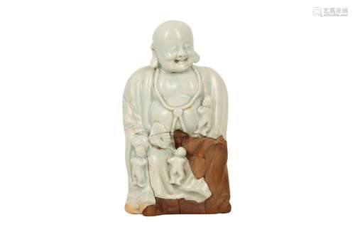 A CHINESE QINGBAI FIGURE OF BUDAI HESHANG AND BOYS.