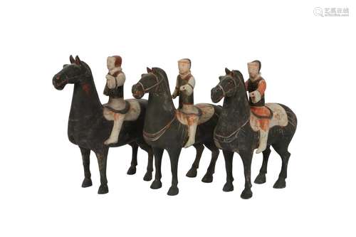 A SET OF THREE CHINESE POTTERY HORSES AND RIDERS.