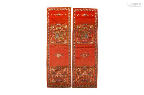 A PAIR OF CHINESE EMBROIDERED RED-GROUND CHAIR COVERS.