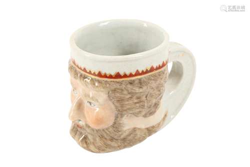 A CHINESE FAMILLE ROSE 'NEPTUNE'S HEAD' MUG.