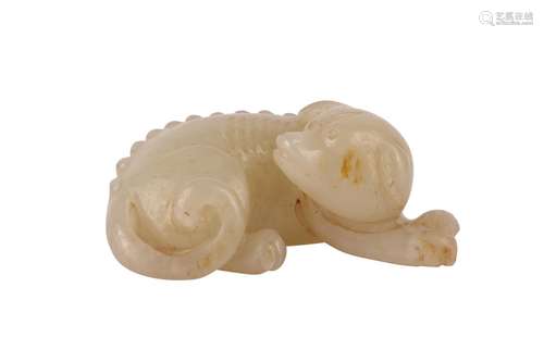 A CHINESE PALE CELADON JADE MODEL OF A DOG.