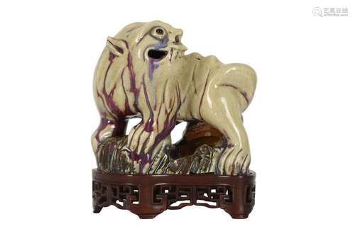 A CHINESE FLAMBÉ-GLAZED MODEL OF A LION DOG.