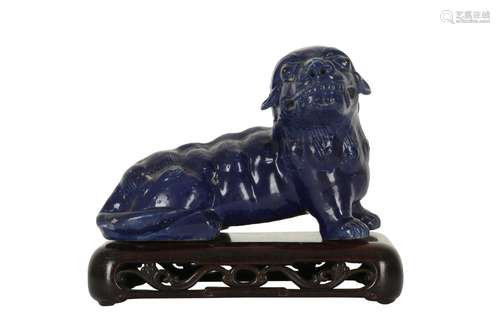 A CHINESE BLUE-GLAZED LION DOG.