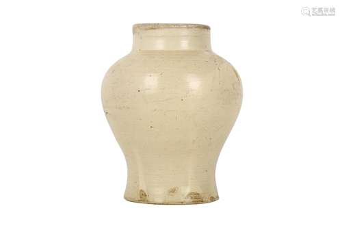 A CHINESE CREAM-GLAZED POTTERY VASE.