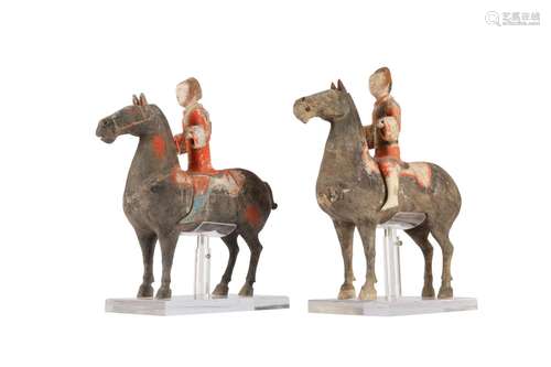 A PAIR OF CHINESE POTTERY HORSES AND RIDERS.