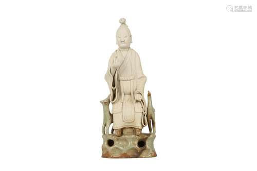 A CHINESE PART-GLAZED BISCUIT FIGURE OF AN IMMORTAL.