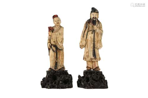 TWO CHINESE STAINED AND GILT-SOAPSTONE FIGURES OF IMMORTALS.