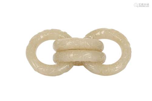 FOUR CHINESE CARVED WHITE JADE CONJOINED RINGS.