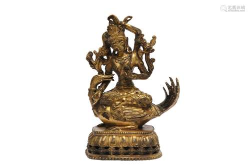 A SINO-TIBETAN GILT-BRONZE FIGURE OF A FOUR-ARMED TARA.