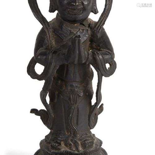 Sujet en bronze représentant un adorant debout sur un lotus,...