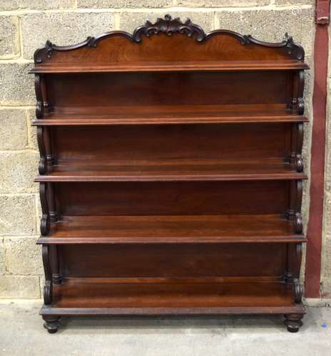 A VICTORIAN WATERFALL BOOKCASE decorated with scrolling