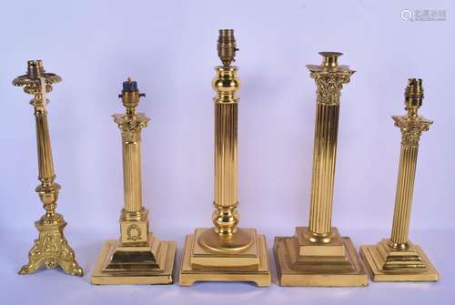 FIVE VINTAGE BRASS CORINTHIAN CANDLESTICK LAMPS.