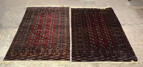 A DEEP RED GROUND PAIR OF CARPET, finely decorated with