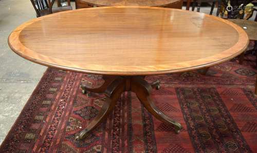 A GEORGE III STYLE MAHOGANY OVAL DINING TABLE. 7…