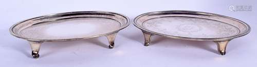 A MATCHED PAIR OF GEORGE III SILVER TEAPOT STANDS.